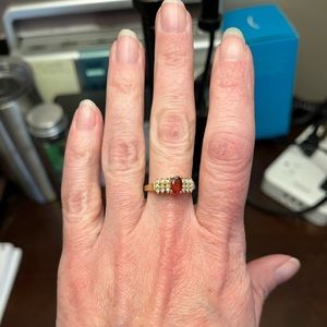 Woman’s 14Ct yellow gold garnet ring with diamond accents